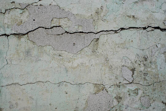 Close up of concrete driveway with a multiple cracks